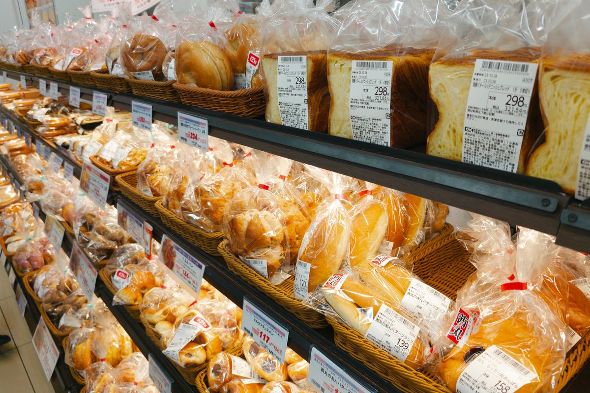 Rows of packaged sliced bread on a grocery store shelf